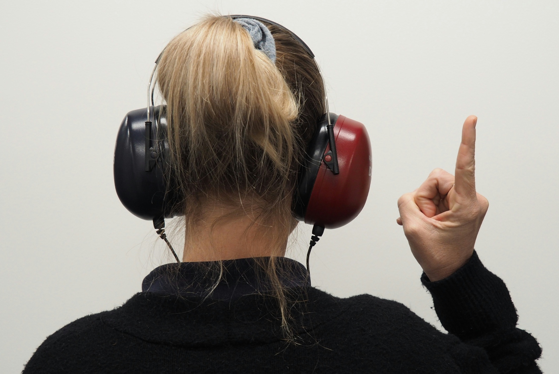 An audiologist sitting with a patient wearing audiometric headphones during a hearing test in Kenfig Hill, Bridgend
