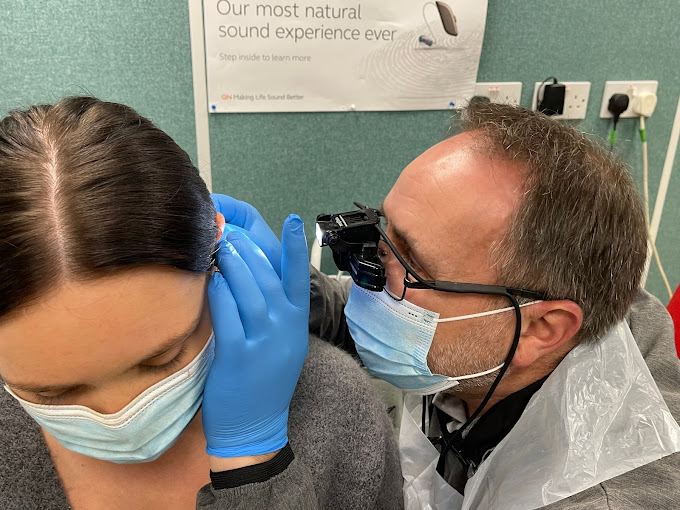 Nick Wootton, audiologist at the Prestige Hearing Bridgend clinic, wearing clinic uniform