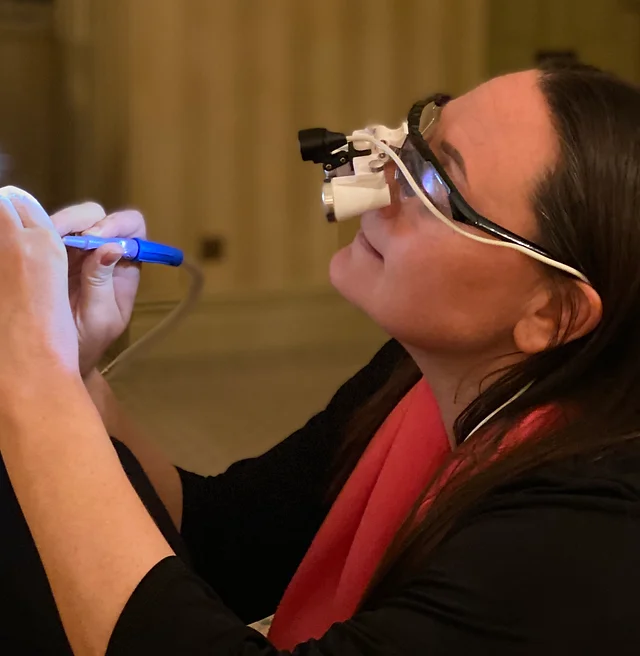 Louise Moss, Cardiff audiologist, performing microsuction earwax removal